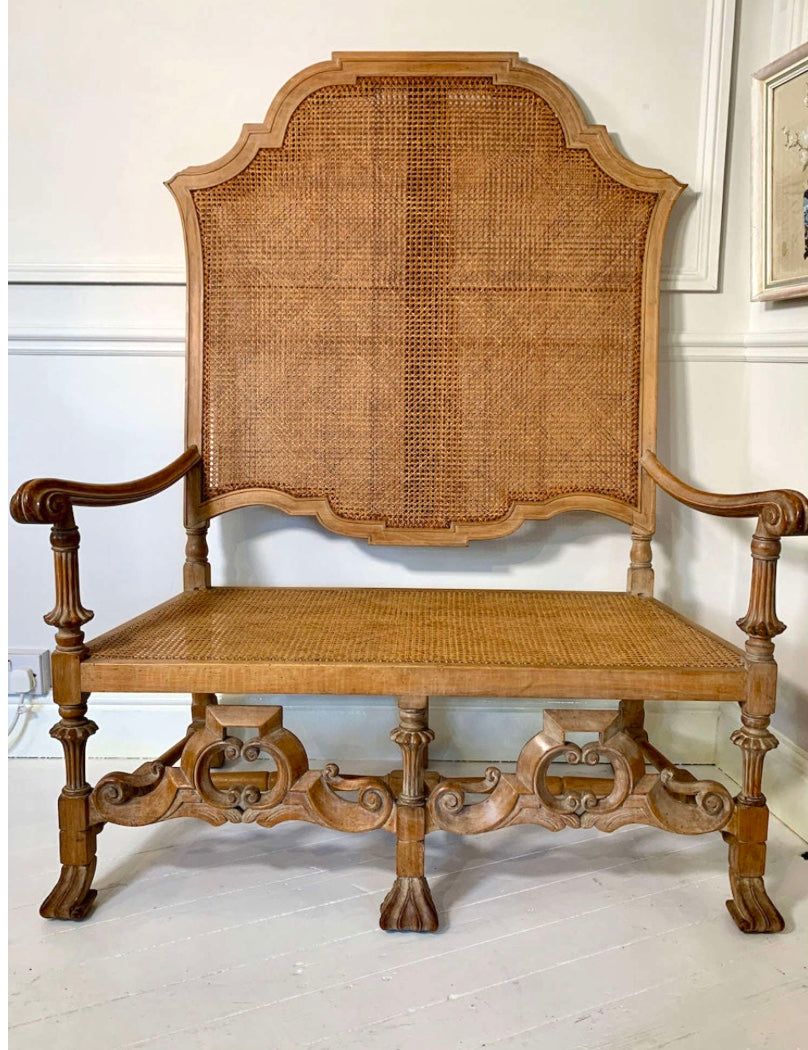 An Italian high quality hand carved Walnut and cane love seat chair.