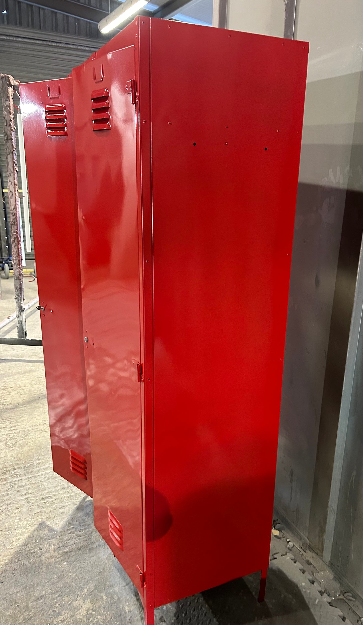 A Refurbished pair of joined Metal lockers finished in cherry apple red.