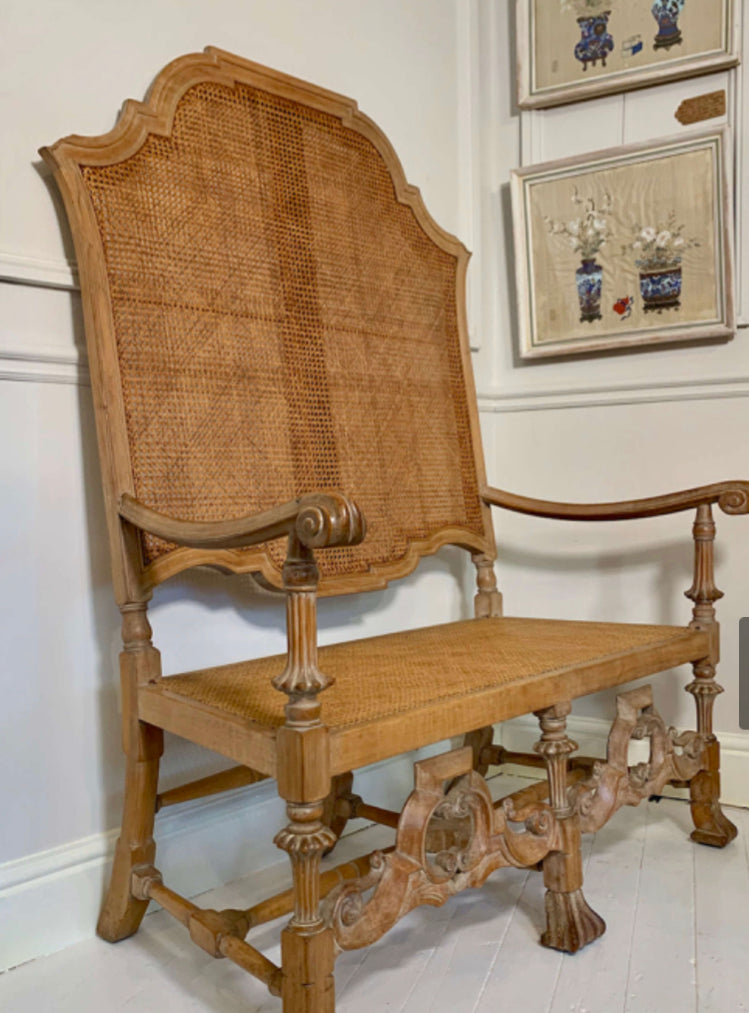 An Italian high quality hand carved Walnut and cane love seat chair.