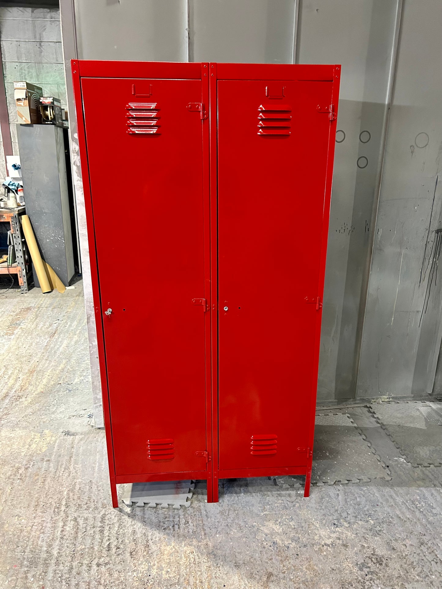 A Refurbished pair of joined Metal lockers finished in cherry apple red.