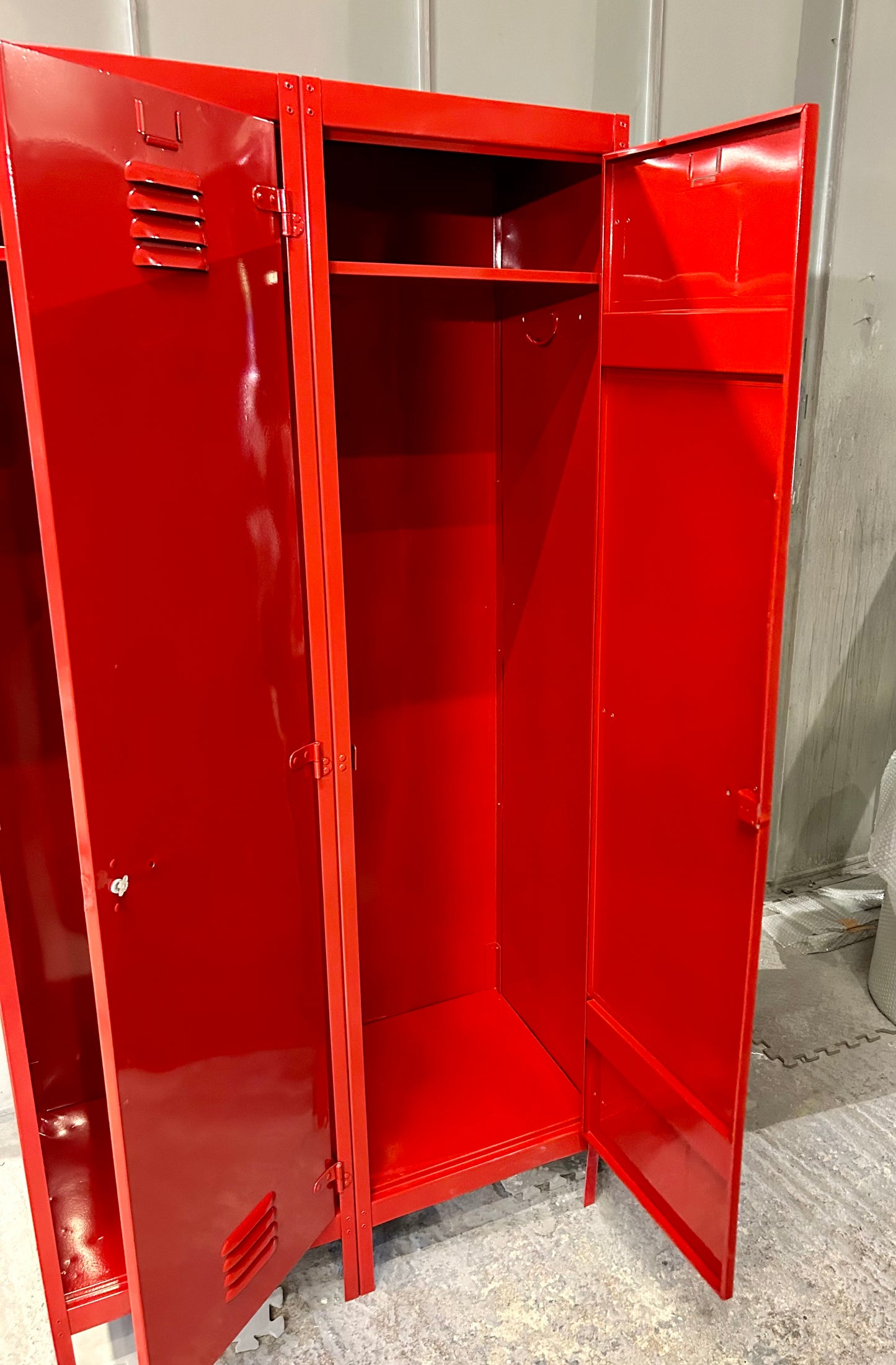 A Refurbished pair of joined Metal lockers finished in cherry apple red.